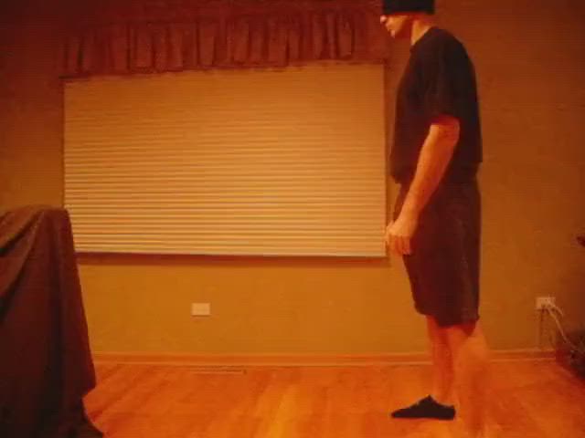 Small girl kicking a big guy in the nuts