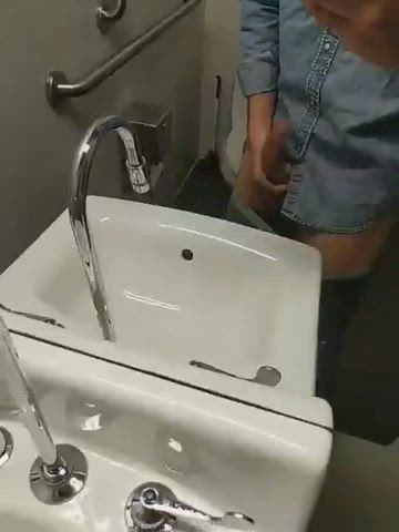Wagging my fat cock around in a restaurant bathroom. My server had huge tits and