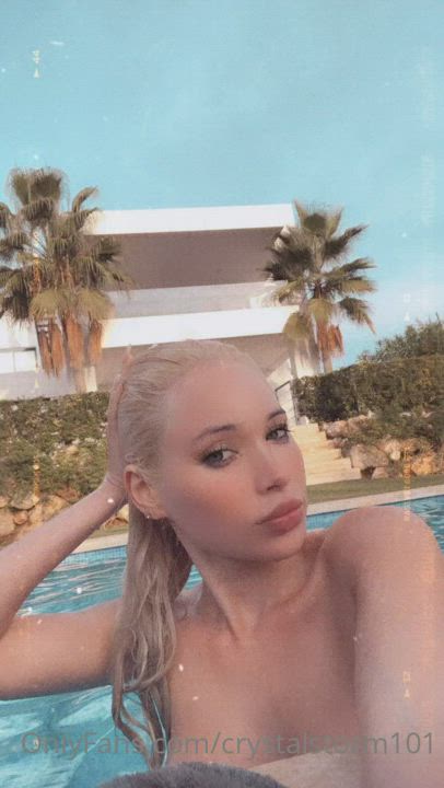 Blonde babe Crystal Storm showing off her big bimbo tits