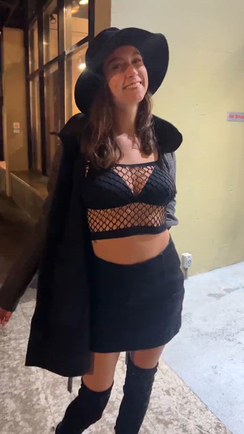 Flashing her tits as she walks down the street