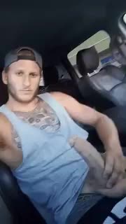 Playing with his cut cock in the car