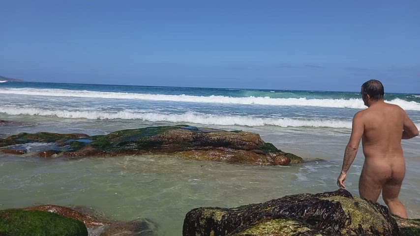 nudist in the beach waves